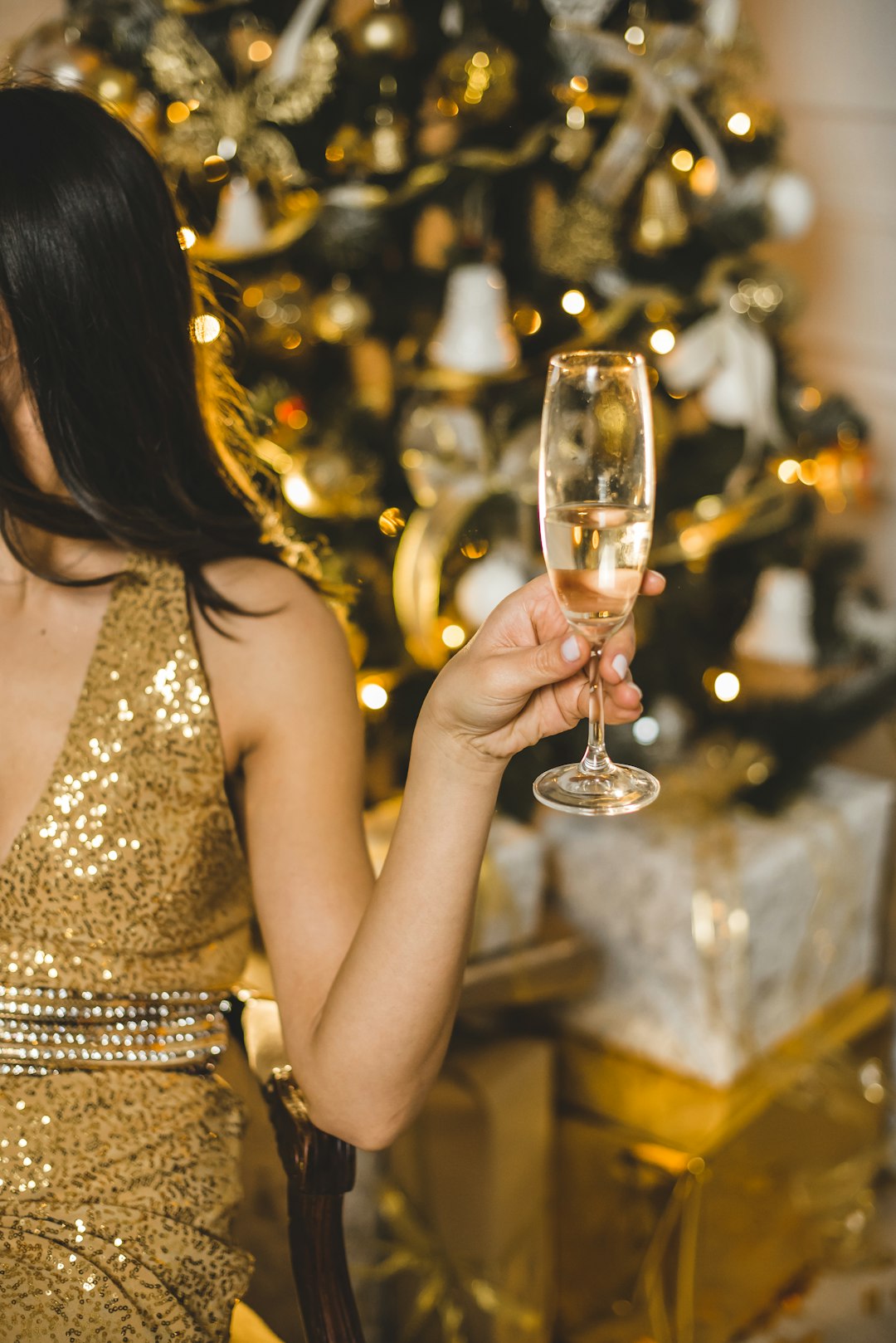 Photo by Kateryna Hliznitsova woman in brown sleeveless dress holding clear wine glass