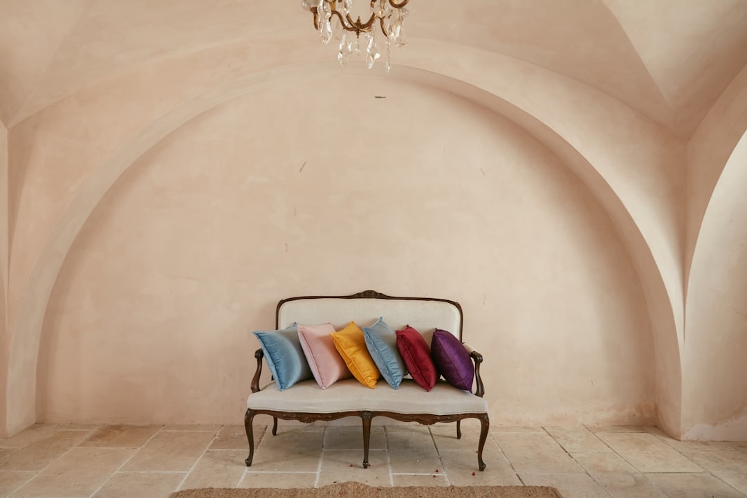 Photo by Deconovo blue and red throw pillows on black armchair